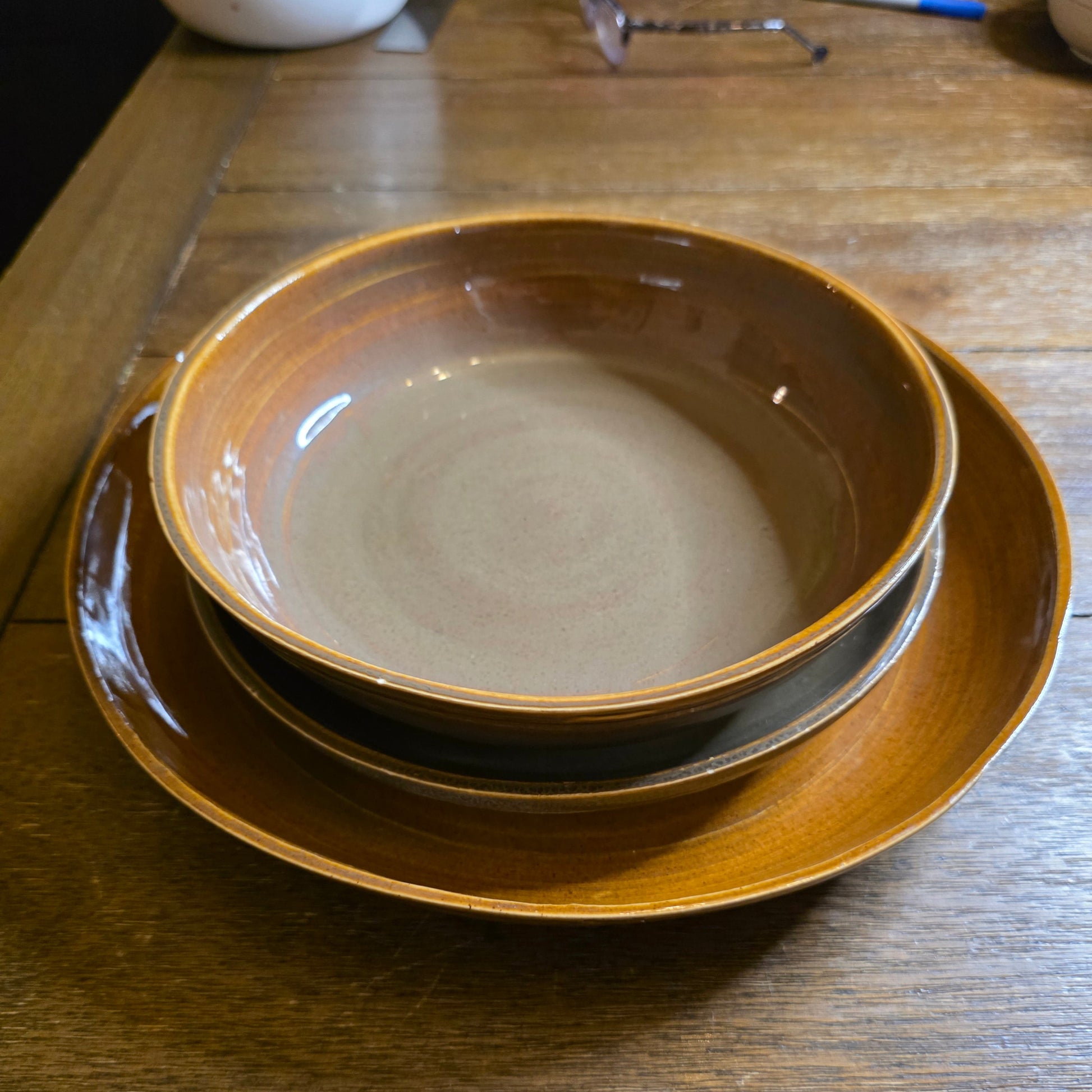 Stack of ceramic bowls on a wooden surface